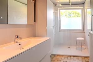 a white bathroom with a sink and a window at Gîte Ô16 in Nassogne +29 photos