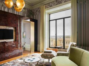 a living room with a couch and a fireplace at Vila Foz Hotel & SPA in Porto