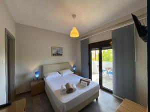 a bedroom with a bed with towels on it at Makis House in Nikiti +240 photos