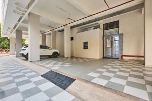 an empty parking lot with a car in a building at Treebo Rio Crown Palace in Ahmedabad