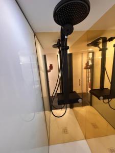 a room with a glass wall with a microphone at Gite Les Oliviers d'Ardèche in Chalencon