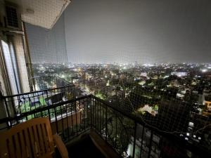 a room with a view of a city at night at The Amberwood Escape in Greater Noida +2 photos