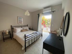 a bedroom with a bed and a large window at Blue Deck Theologos in Theologos