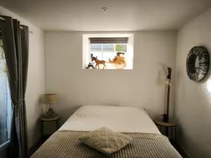 a bedroom with a bed with a horse in the window at Limousin, Saint Vitte sur Briance Vacances au Mazet de Nova in Martageix