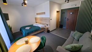 a hotel room with a bed and a table at LEMAR APART Tatry F205 in Veľká Lomnica +26 photos