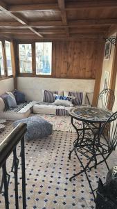 a living room with a table and a couch at Dar Imran in Tangier