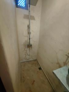 a small bathroom with a shower in the corner at Dar Imran in Tangier
