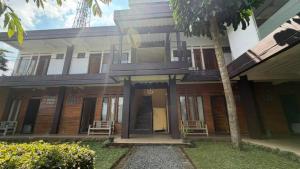 a building with two chairs in front of it at Jayagiri Inn in Tangkubanperahu