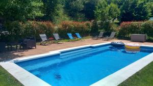 a large swimming pool with chairs in a yard at Casiñas De Acevedo in Junquera de Ambía