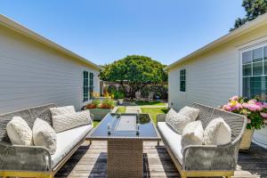 a patio with wicker furniture and a table at Walkable Mill Valley Gem: Private Patio + Yard in Mill Valley