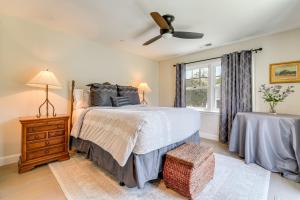 a bedroom with a bed and a ceiling fan at Walkable Mill Valley Gem: Private Patio + Yard in Mill Valley