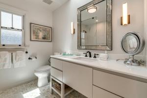 a white bathroom with a sink and a toilet at Walkable Mill Valley Gem: Private Patio + Yard in Mill Valley +20 photos