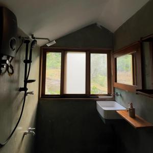 a bathroom with a sink and a window at Visari Fall Villa Ella in Ella +47 photos