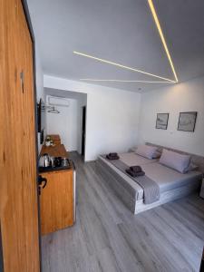 a bedroom with a bed and a television in it at Palms Guest House in Himare