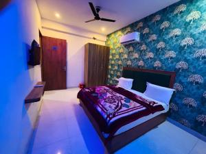 a bedroom with a bed and a blue wall at Hotel Meera in Bāwal