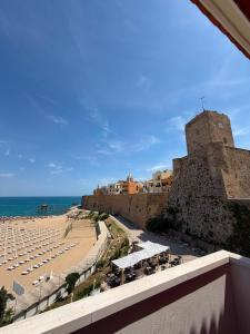 a view of a beach with chairs and a castle at Hotel Santa Lucia in Termoli