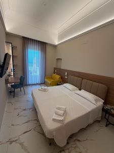 a bedroom with a large bed with towels on it at Hotel Santa Lucia in Termoli