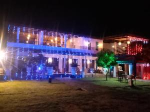 a building decorated with christmas lights at night at Kataragama Brain Hotel in Kataragama