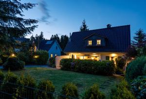 a house with lights on in a yard at night at Schneekäppchen 1 in Winterberg