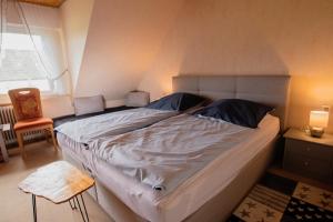 a large bed in a room with a window at Doppelzimmer mit Dusche und Wc in Lennestadt +10 photos