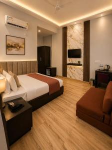 a hotel room with a bed and a couch at Nandan Retreat 4-Star Hotel & Luxury Villas Near Prem Mandir, Vrindavan in Vrindāvan
