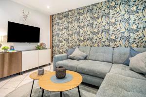 a living room with a couch and a tv at Kleines Stadthaus mit Sauna in Hillesheim