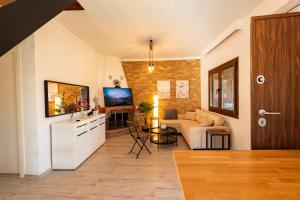 a living room with a couch and a table at Holiday Home Potidaia in Nea Potidaea