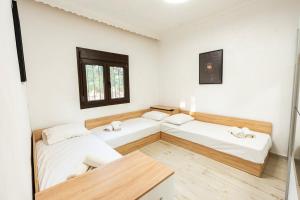 a room with two beds and a table at Holiday Home Potidaia in Nea Potidaea +21 photos