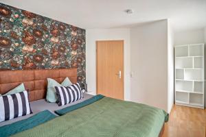 a bedroom with a large bed with pillows at Kleines Stadthaus mit Sauna in Hillesheim