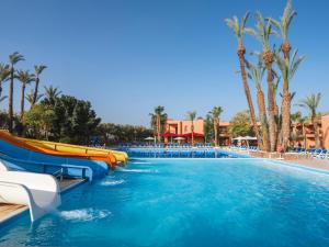 a water slide in a pool at a resort at Aqualis Club Resort Marrakech in Marrakesh
