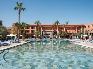 a large swimming pool in front of a hotel at Aqualis Club Resort Marrakech in Marrakesh