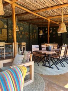a living room with a wooden table and a couch at Marini Ndoto in Themi