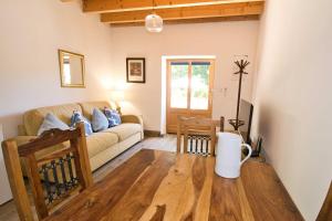 a living room with a couch and a table at The Lodge Gite 3 Star in Saint-Privat-des-Prés