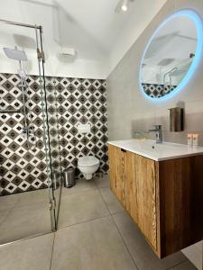 a bathroom with a shower and a sink and a mirror at Hotel U Feldů in Klimkovice +45 photos
