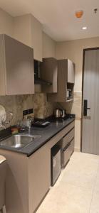 a kitchen with a sink and a counter top at Stay Karo Yaar in Ghaziabad