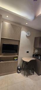 a kitchen with a table and a clock on the wall at Stay Karo Yaar in Ghaziabad +2 photos