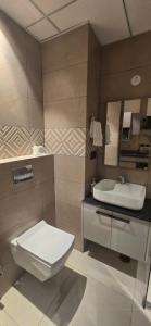 a bathroom with a toilet and a sink at Stay Karo Yaar in Ghaziabad