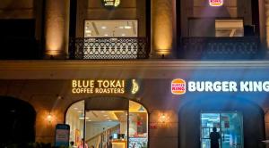 a building with a blue toka coffee transactions sign on it at Stay Karo Yaar in Ghaziabad