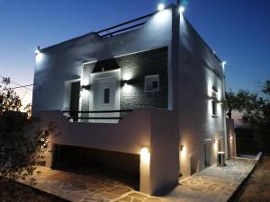 a building with lights on the side of it at Countryside Retreat 1 in Agios Arsenios