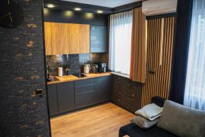 a kitchen with a couch and a table in a room at Kaszmir Apartments in Opole