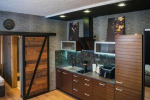 a kitchen with a sink and a counter at Kaszmir Apartments in Opole +12 photos