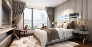 a bedroom with a bed and a desk and a window at Aahotel by ABCIS in Phước Mỹ