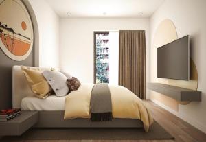 a bedroom with a bed and a flat screen tv at Aahotel by ABCIS in Phước Mỹ