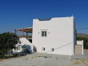 a white building with a staircase next to it at Countryside Retreat 1 in Agios Arsenios