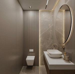 a bathroom with a sink and a toilet and a mirror at Aahotel by ABCIS in Phước Mỹ
