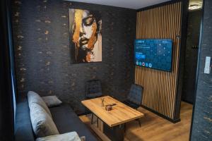 a living room with a table and a couch at Kaszmir Apartments in Opole