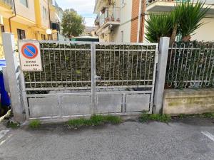 a gate with a no parking sign on it at Appartamento Zero Pensieri in San Benedetto del Tronto