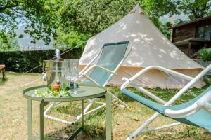a table and a chair and a tent at Paradise Glamping in Saint Vincent