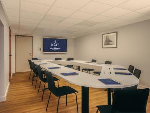 a large conference room with a long table and chairs at Hotel Coeur Marin in Les Sables-d'Olonne