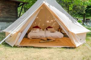 a white tent with two beds in it at Paradise Glamping in Saint Vincent